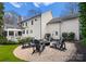 Backyard firepit with seating creating an inviting outdoor gathering space, surrounded by gravel and landscaping at 846 Wriston Pl, Charlotte, NC 28209