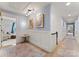 Hallway with hardwood floors, wainscoting, artwork, and doorways to other living spaces at 846 Wriston Pl, Charlotte, NC 28209
