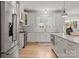 Bright kitchen with white cabinets, stainless steel appliances, and a marble island at 846 Wriston Pl, Charlotte, NC 28209