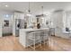Bright kitchen with a large island, white cabinetry, and stainless steel appliances at 846 Wriston Pl, Charlotte, NC 28209