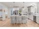 Open-concept kitchen featuring white cabinets, marble countertops, and modern appliances at 846 Wriston Pl, Charlotte, NC 28209