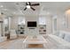 Bright living room with coffered ceilings, custom built-ins, and white furniture for a light and airy feel at 846 Wriston Pl, Charlotte, NC 28209