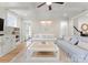 Open-concept living room featuring light hardwood floors, a shaggy rug, and comfortable seating at 846 Wriston Pl, Charlotte, NC 28209