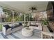 Relaxing screened porch with comfortable seating, ceiling fan, and views of the surrounding yard at 846 Wriston Pl, Charlotte, NC 28209