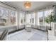 Inviting sunroom with an abundance of natural light, neutral colors, and comfortable seating at 846 Wriston Pl, Charlotte, NC 28209