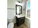 Bathroom features a single sink vanity, dark cabinets, modern fixtures, and tile floors at 8827 Wingard Rd, Waxhaw, NC 28173