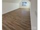 Open bonus room featuring wood-look flooring and natural light from an architectural window at 8827 Wingard Rd, Waxhaw, NC 28173