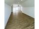 Spacious bonus room featuring wood-look floors, recessed lighting, and bright white walls at 8827 Wingard Rd, Waxhaw, NC 28173