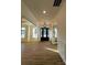 Inviting entryway features a stylish front door, chandelier, wood floors, and detailed trim work at 8827 Wingard Rd, Waxhaw, NC 28173