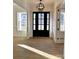 Inviting entryway features a stylish front door, chandelier, wood floors, and detailed trim work at 8827 Wingard Rd, Waxhaw, NC 28173