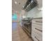 Upscale kitchen features large stainless steel range, custom cabinets, and a seamless connection to the dining area at 8827 Wingard Rd, Waxhaw, NC 28173
