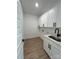 Clean laundry room showcasing white cabinetry, a stainless sink, and modern black hardware at 8827 Wingard Rd, Waxhaw, NC 28173