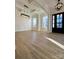 Spacious living area with an open floor plan, wood floors, coffered ceilings, and plenty of natural light at 8827 Wingard Rd, Waxhaw, NC 28173