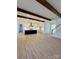 Expansive open-concept living space offers hardwood floors, wood beam ceilings, and modern lighting at 8827 Wingard Rd, Waxhaw, NC 28173