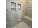This shower features marble-look tile, a built-in corner bench, and convenient built-in storage shelves at 8827 Wingard Rd, Waxhaw, NC 28173