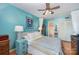 Light bedroom featuring hardwood floors, teal walls, ceiling fan and a view to the ensuite bathroom at 912 Mcalway Rd # D, Charlotte, NC 28211