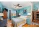 Stylish bedroom with hardwood floors, ceiling fan, and teal walls at 912 Mcalway Rd # D, Charlotte, NC 28211