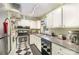 Well-equipped kitchen featuring stainless steel appliances, checkered floors, and ample cabinet space at 912 Mcalway Rd # D, Charlotte, NC 28211
