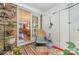 Charming sunroom with brick accent wall, colorful rug, and view into living room at 912 Mcalway Rd # D, Charlotte, NC 28211