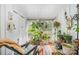 Bright sunroom featuring an array of potted plants, colorful rug, and lots of natural light at 912 Mcalway Rd # D, Charlotte, NC 28211