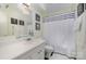 Bright bathroom featuring a vanity with a sink, a toilet, and a shower with a black and white curtain at 912 Mcalway Rd # D, Charlotte, NC 28211
