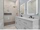 Lavish bathroom with double sink vanity, lighted mirrors, and glass enclosed shower at 913 Wilson W Lee Blvd, Statesville, NC 28677