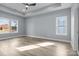 Large bedroom with multiple windows, tray ceiling and hardwood-style floors at 913 Wilson W Lee Blvd, Statesville, NC 28677
