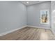 Bright bedroom featuring hardwood-style flooring and a window overlooking the backyard at 913 Wilson W Lee Blvd, Statesville, NC 28677