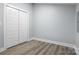 Bedroom featuring vinyl plank flooring, neutral walls, and a double door closet at 913 Wilson W Lee Blvd, Statesville, NC 28677