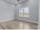 Minimalist bedroom featuring sleek, light floors, neutral walls, and a large window, creating a serene atmosphere at 913 Wilson W Lee Blvd, Statesville, NC 28677