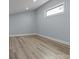 Clean and modern bedroom showcasing neutral walls, vinyl plank floors, and single window at 913 Wilson W Lee Blvd, Statesville, NC 28677