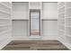 Walk-in closet featuring custom shelving, mirror, and neutral vinyl plank floors at 913 Wilson W Lee Blvd, Statesville, NC 28677