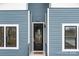 Close-up of the front door with black frame, modern handle, and welcome mat at 913 Wilson W Lee Blvd, Statesville, NC 28677