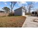 A detached single-car garage with blue siding and a concrete driveway, nestled in a spacious backyard with sparse grass at 913 Wilson W Lee Blvd, Statesville, NC 28677