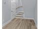Hallway showing a staircase and door, featuring hardwood-style flooring at 913 Wilson W Lee Blvd, Statesville, NC 28677