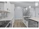 Modern kitchen featuring an island sink, quartz countertops, stainless steel appliances, and stylish backsplash at 913 Wilson W Lee Blvd, Statesville, NC 28677