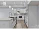 Modern kitchen features an island sink, white cabinets, stylish backsplash, and stainless steel appliances at 913 Wilson W Lee Blvd, Statesville, NC 28677