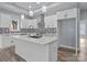 Beautiful kitchen with white cabinetry, large island with a quartz countertop, stainless steel appliances, and wood floors at 913 Wilson W Lee Blvd, Statesville, NC 28677