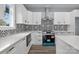 Modern kitchen featuring quartz countertops, stainless steel appliances, and stylish backsplash at 913 Wilson W Lee Blvd, Statesville, NC 28677