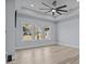 Spacious bedroom featuring sleek, light floors, neutral walls, and three large windows, creating a serene atmosphere at 913 Wilson W Lee Blvd, Statesville, NC 28677
