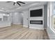 Contemporary open-concept living space with sleek flooring, a fireplace, and a view of the modern kitchen and bar seating at 913 Wilson W Lee Blvd, Statesville, NC 28677