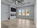 Modern living room with a sleek ceiling fan, recessed lights, a fireplace, and expansive windows providing abundant natural light at 913 Wilson W Lee Blvd, Statesville, NC 28677