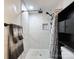 Bathroom featuring a shower with white tile and a black shelf at 101 Loya St, Mount Holly, NC 28120