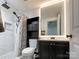 Bathroom featuring a shower with black fixtures and a vanity with a light up mirror at 101 Loya St, Mount Holly, NC 28120