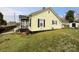 A yellow house with black shutters and a green lawn at 101 Loya St, Mount Holly, NC 28120
