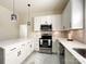 Modern kitchen with stainless steel appliances, quartz countertops, and stylish fixtures at 101 Loya St, Mount Holly, NC 28120