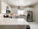 A well-lit kitchen featuring stainless steel appliances, white cabinetry, and marble countertops at 101 Loya St, Mount Holly, NC 28120