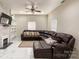 Cozy living room featuring a large sectional sofa, fireplace, and bright windows at 101 Loya St, Mount Holly, NC 28120