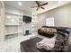 Bright living room with large sectional, modern fireplace, and custom shelving at 101 Loya St, Mount Holly, NC 28120