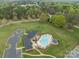 Aerial view of pool and clubhouse with ample parking and lush, green surroundings at 102 Wyndham Way, Salisbury, NC 28147